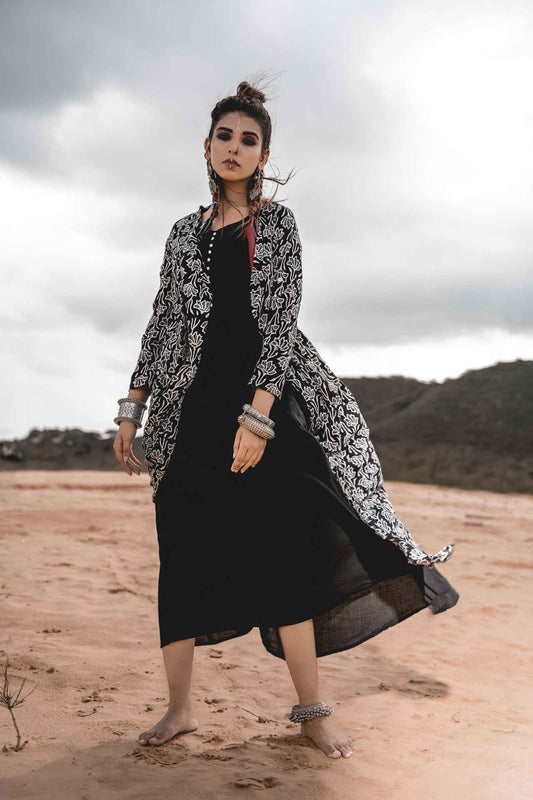 Black Rayon Dress With Cotton Block Printed Asymmetric Cape - Set Of 2 by Keva with Black, Block Prints, Cape, Co-ord Sets, Cotton, Dress Sets, For Mother, For Mother W, Jackets, Midi Dresses, Natural, Relaxed Fit, Resort Wear, Wild Child, Womenswear at Kamakhyaa for sustainable fashion