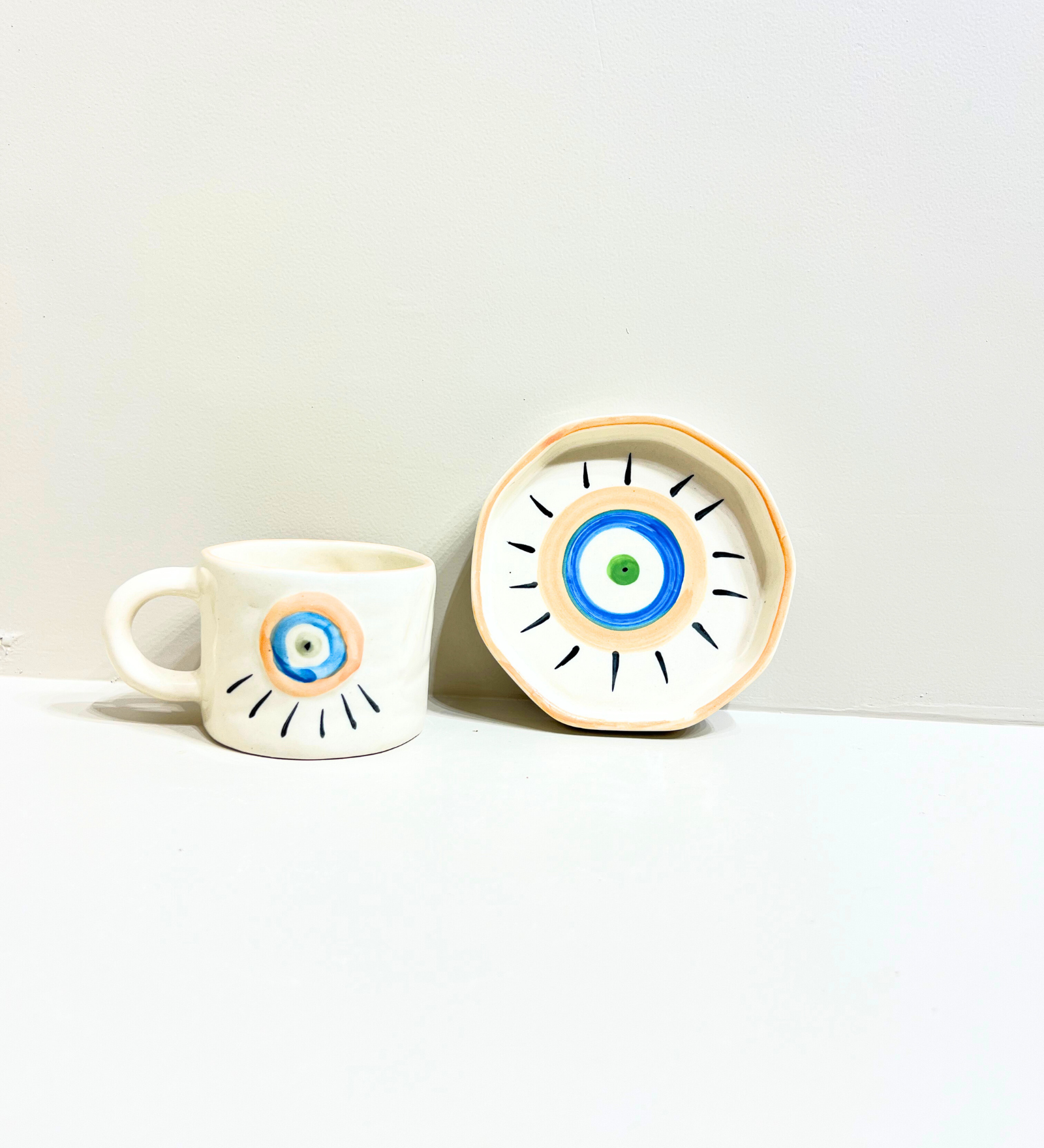Sunstone Gaze – Evil Eye Ceramic Mug & Plate Set by Aetherea World with at Kamakhyaa for sustainable fashion