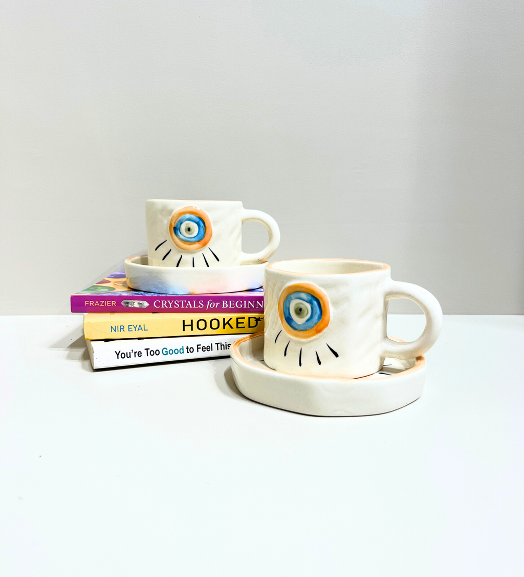 Sunstone Gaze – Evil Eye Ceramic Mug & Plate Set by Aetherea World with at Kamakhyaa for sustainable fashion