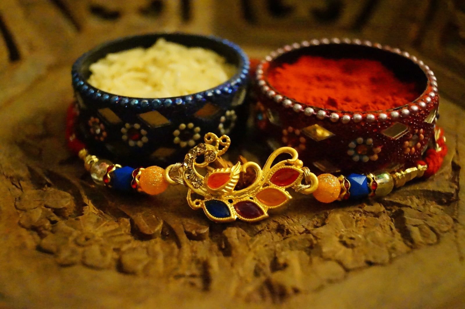 Peaccock Colorful Stone and Gold Brass Thread Rakhi by Kamakhyaa with Brass, Festive Wear, Multicolor, Natural Materials, Natural Threads, Rakhi, Rakhis Ready to Ship, Regular Fit, Upcycled, Zari Threads at Kamakhyaa for sustainable fashion