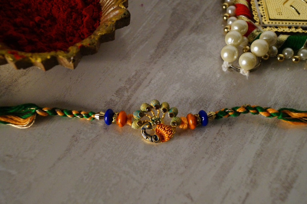 Peacock Stone and Colorful Stone Thread Rakhi by Kamakhyaa with Festive Wear, Jewellery, Multicolor, Natural Materials, Natural Threads, Peacock, Rakhi, Rakhis Ready to Ship, Regular Fit, Upcycled, Zari Threads at Kamakhyaa for sustainable fashion