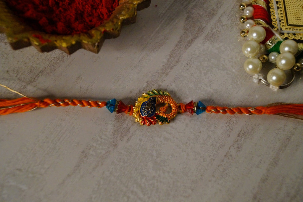 Set of 2-Peacock Gold Brass Thread Rakhi by Kamakhyaa with Brass, Festive Wear, Jewellery, Multicolor, Natural Materials, Natural Threads, Rakhi, Rakhis Ready to Ship, Regular Fit, Upcycled, Zari Threads at Kamakhyaa for sustainable fashion