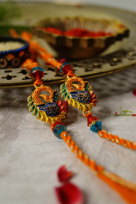 Set of 2-Peacock Gold Brass Thread Rakhi by Kamakhyaa with Brass, Festive Wear, Jewellery, Multicolor, Natural Materials, Natural Threads, Rakhi, Rakhis Ready to Ship, Regular Fit, Upcycled, Zari Threads at Kamakhyaa for sustainable fashion