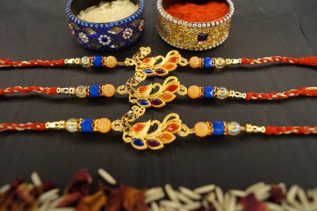 Set of 3-Peacock Colorful Stone Thread Rakhi by Kamakhyaa with Festive Wear, Jewellery, Multicolor, Natural Materials, Natural Threads, Peacock, Rakhi, Rakhis Ready to Ship, Regular Fit, Upcycled, Zari Threads at Kamakhyaa for sustainable fashion