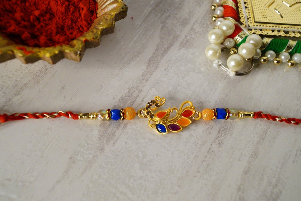 Set of 3-Peacock Colorful Stone Thread Rakhi by Kamakhyaa with Festive Wear, Jewellery, Multicolor, Natural Materials, Natural Threads, Peacock, Rakhi, Rakhis Ready to Ship, Regular Fit, Upcycled, Zari Threads at Kamakhyaa for sustainable fashion