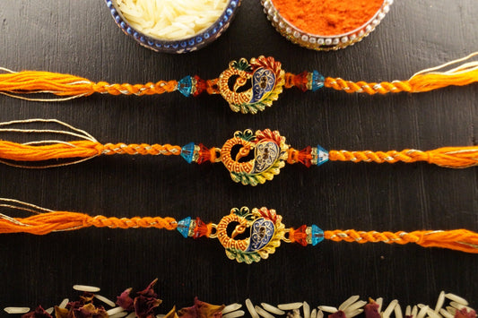 Set of 3-Peacock Gold Brass Thread Rakhi by Kamakhyaa with Brass, Festive Wear, Jewellery, Multicolor, Natural Materials, Natural Threads, Rakhi, Rakhis Ready to Ship, Regular Fit, Upcycled, Zari Threads at Kamakhyaa for sustainable fashion