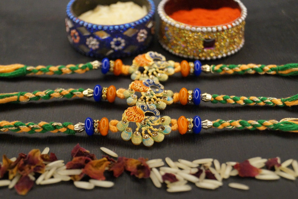 Set of 3-Peacock Stone Thread Rakshi by Kamakhyaa with Festive Wear, Jewellery, Multicolor, Natural Materials, Natural Threads, Peacock, Rakhi, Rakhis Ready to Ship, Regular Fit, Upcycled, Zari Threads at Kamakhyaa for sustainable fashion