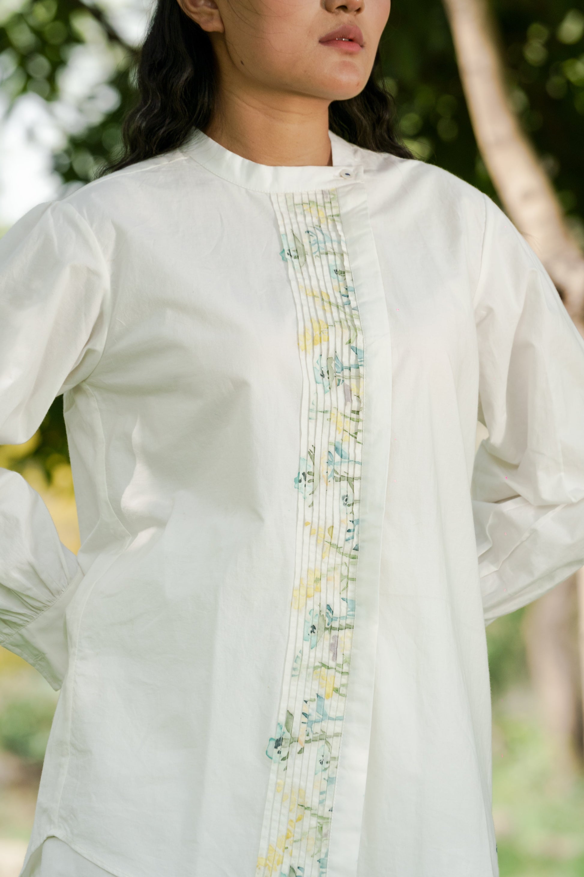 White Pleated placket shirt by Ahmev with Batik, Casual Wear, Cottage Garden, Cottage Garden by Ahmev, Cotton, Handpainted, July Sale, July Sale 2023, Natural, Prints, Regular Fit, Shirts, Tops, White, Womenswear at Kamakhyaa for sustainable fashion