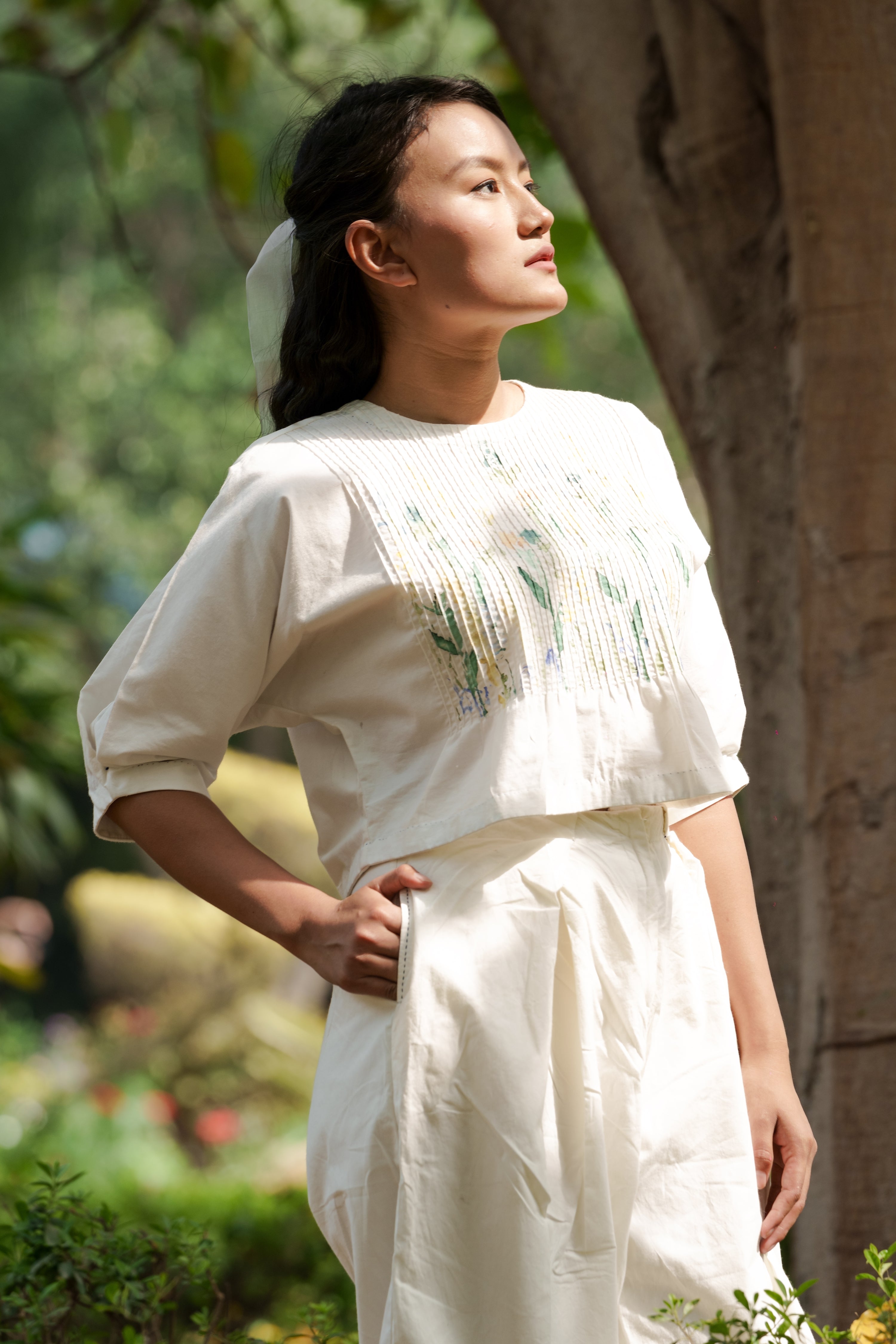 Ivory pleated pants by Ahmev with Batik, Casual Wear, Cottage Garden, Cottage Garden by Ahmev, Cotton, Fitted At Waist, Handpainted, July Sale, July Sale 2023, Natural, Pants, Solids, White, Womenswear at Kamakhyaa for sustainable fashion