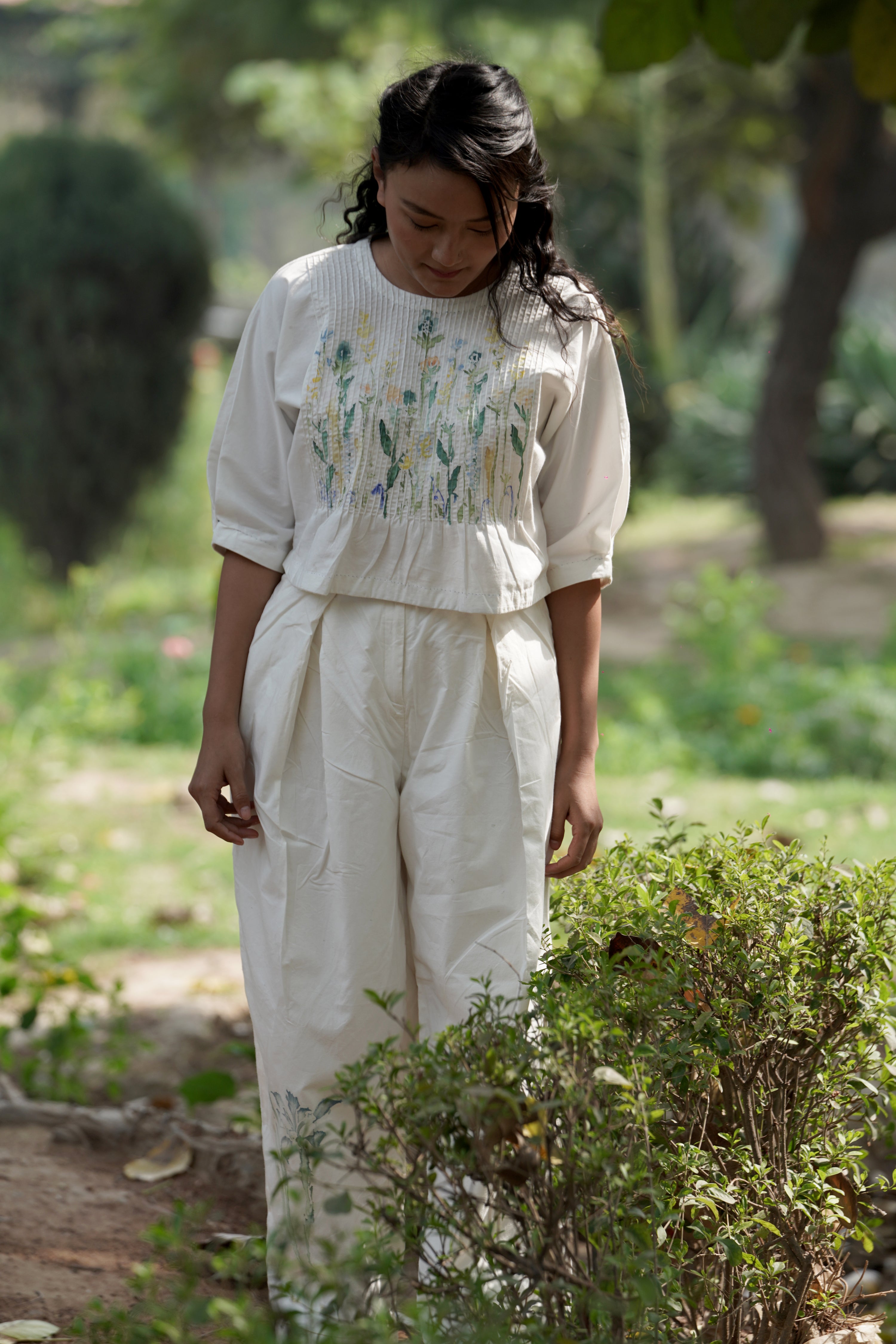 Ivory pleated pants by Ahmev with Batik, Casual Wear, Cottage Garden, Cottage Garden by Ahmev, Cotton, Fitted At Waist, Handpainted, July Sale, July Sale 2023, Natural, Pants, Solids, White, Womenswear at Kamakhyaa for sustainable fashion
