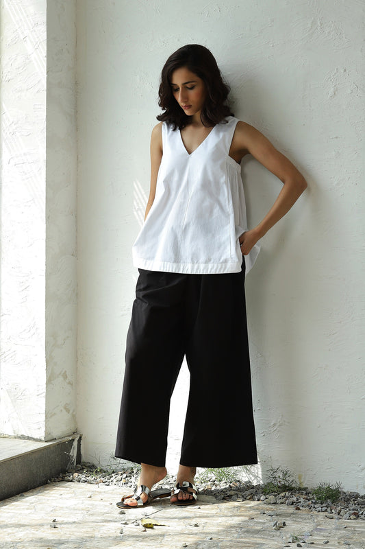 White Sleeveless V Neck Top With Black Flared Pant Set by Canoopi with Black, Canoopi, Casual Wear, Complete Sets, Natural, Poplin, Regular Fit, Solids, Vacation Co-ords, White, Womenswear at Kamakhyaa for sustainable fashion