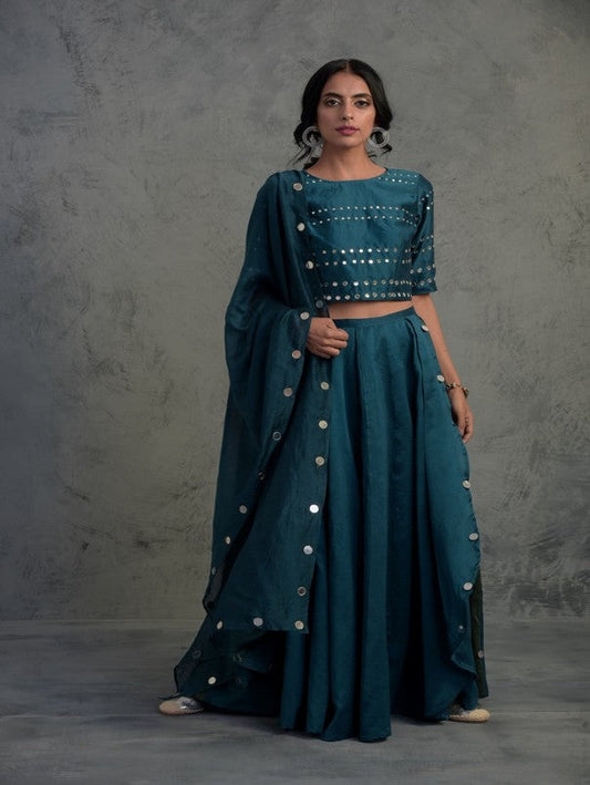 Teal Blue Crop Top Wrap Lehenga Set Of 3 by Charkhee with Blue, Chanderi, Cotton, Embellished, Ethnic Wear, Indian Wear, Lehenga Sets, Mirror Work, Natural, Relaxed Fit, Tyohaar by Charkhee, Wedding Gifts, Womenswear at Kamakhyaa for sustainable fashion